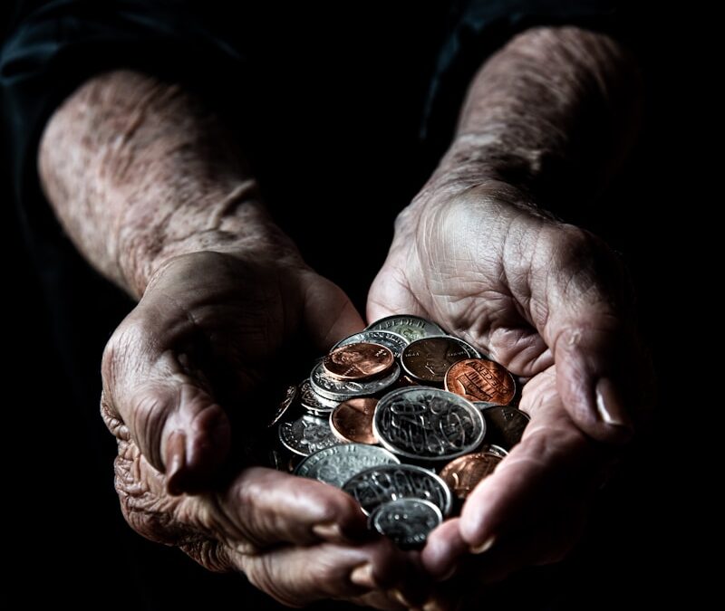 person holding silver round coins